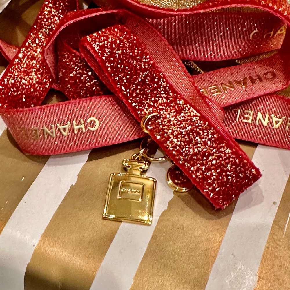 Chanel Gold perfume bottle ornament.